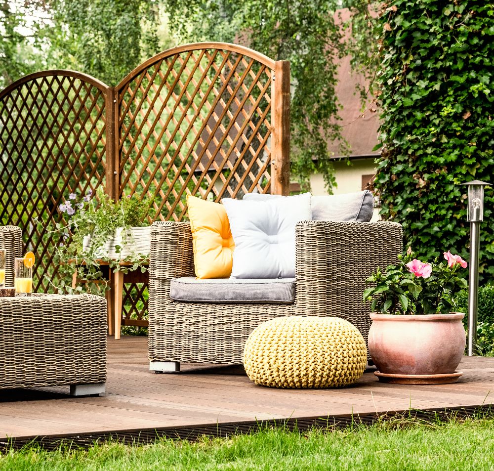 An outdoor patio at dusk with a fire feature and soft, warm lighting